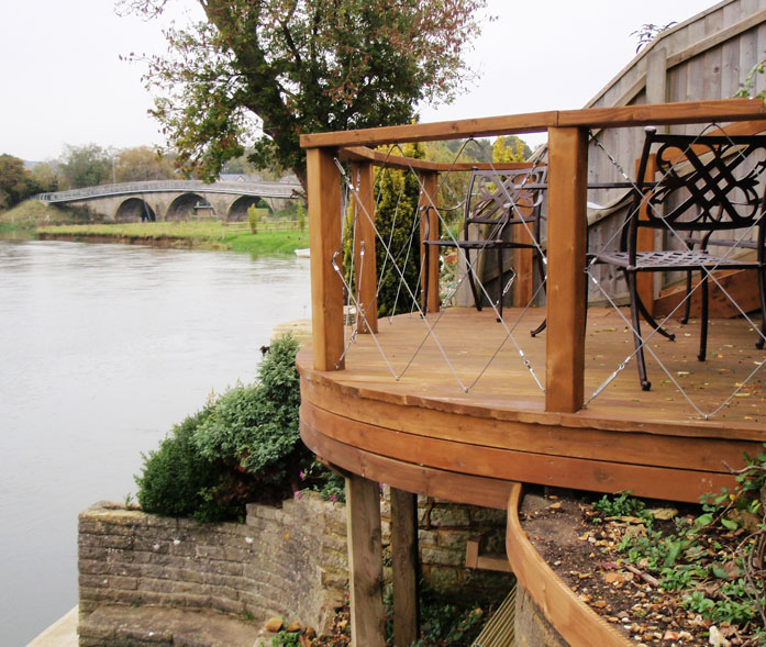 Treated and stained softwood deck with cable railings.