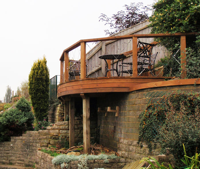 Treated and stained softwood deck with cable railings.