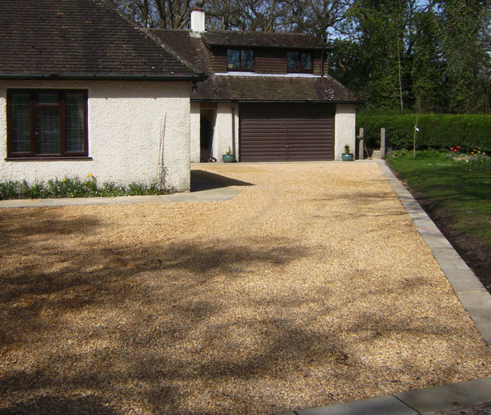 Dorset shingle driveway with honeycomb reinforcing grids to give hard surface. Limestone edging.