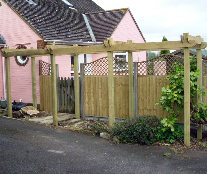 Concrete posts with close board fence panels, curved trellis and pergola.