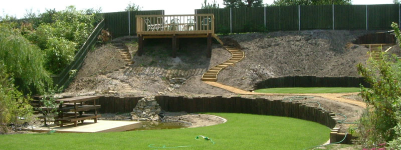 Landscaped bank, with walkways and raised decking area over looking the garden and pond